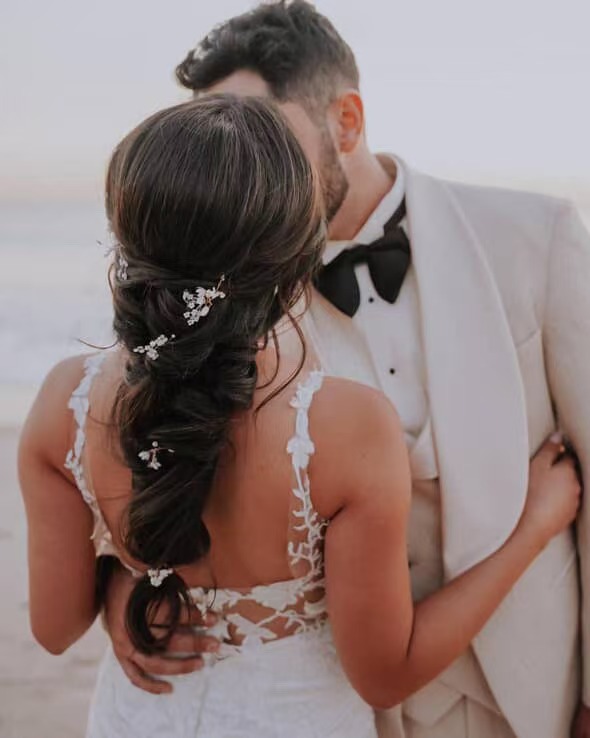 Textured bridal braid with delicate hair accessories